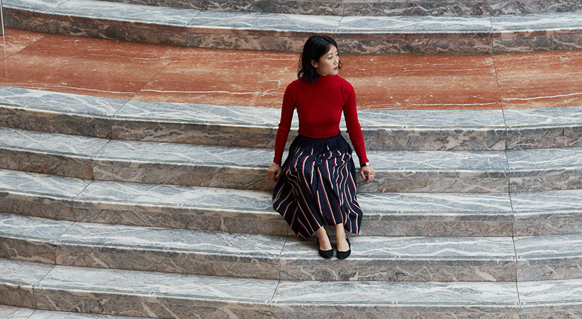Alice Gao sitting on marble steps in BFPLNY